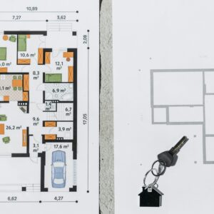 A comprehensive floor plan layout featuring a house key symbolizing real estate and homeownership.